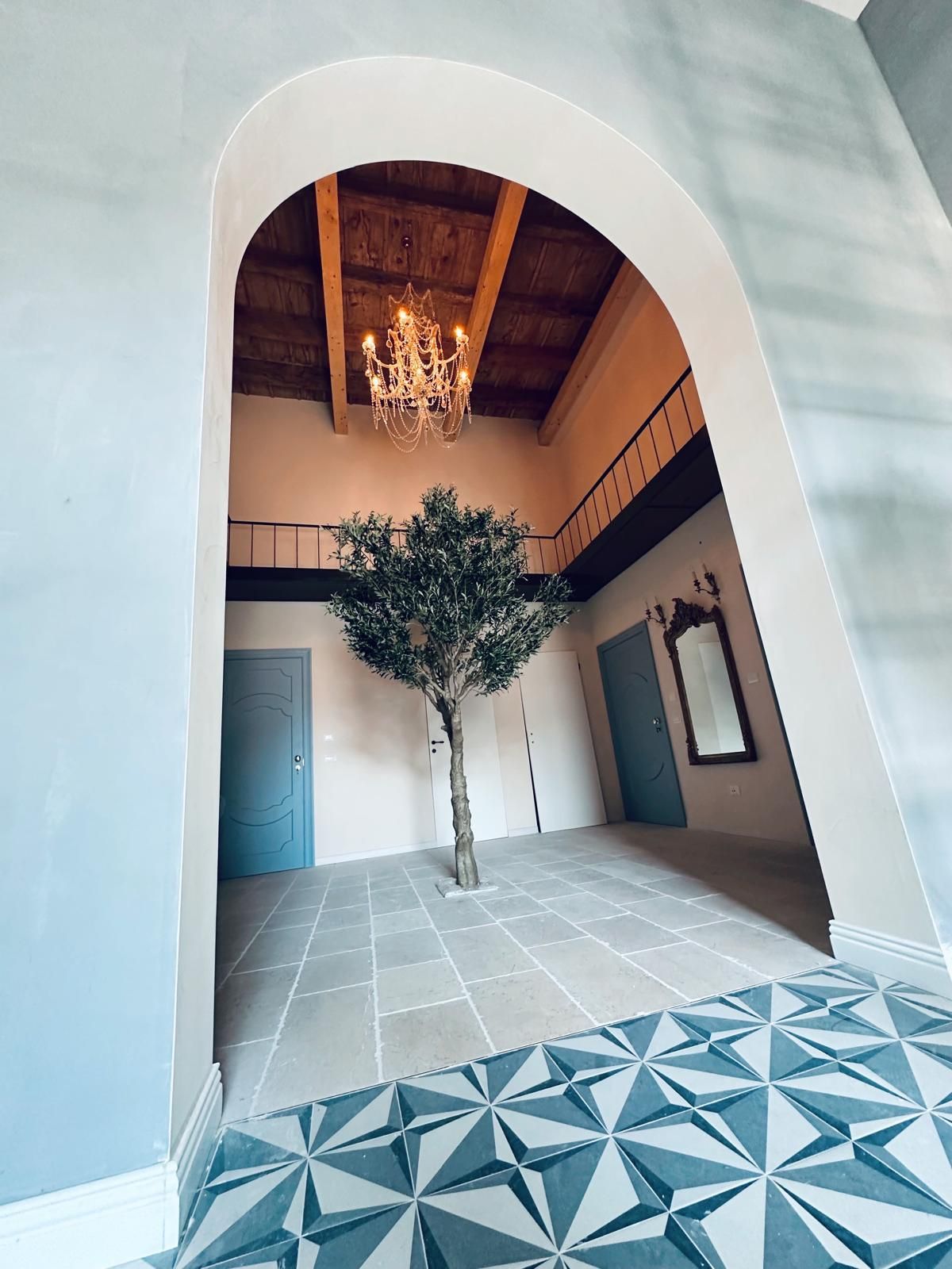 Through the arch to the olive tree hall.