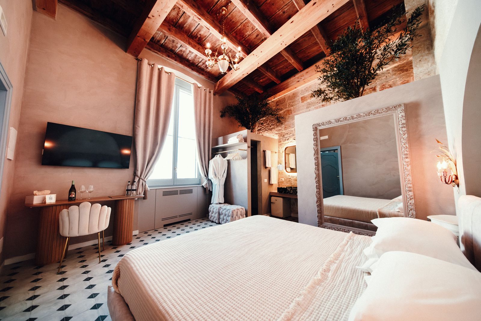 The bed under the old wooden beams.