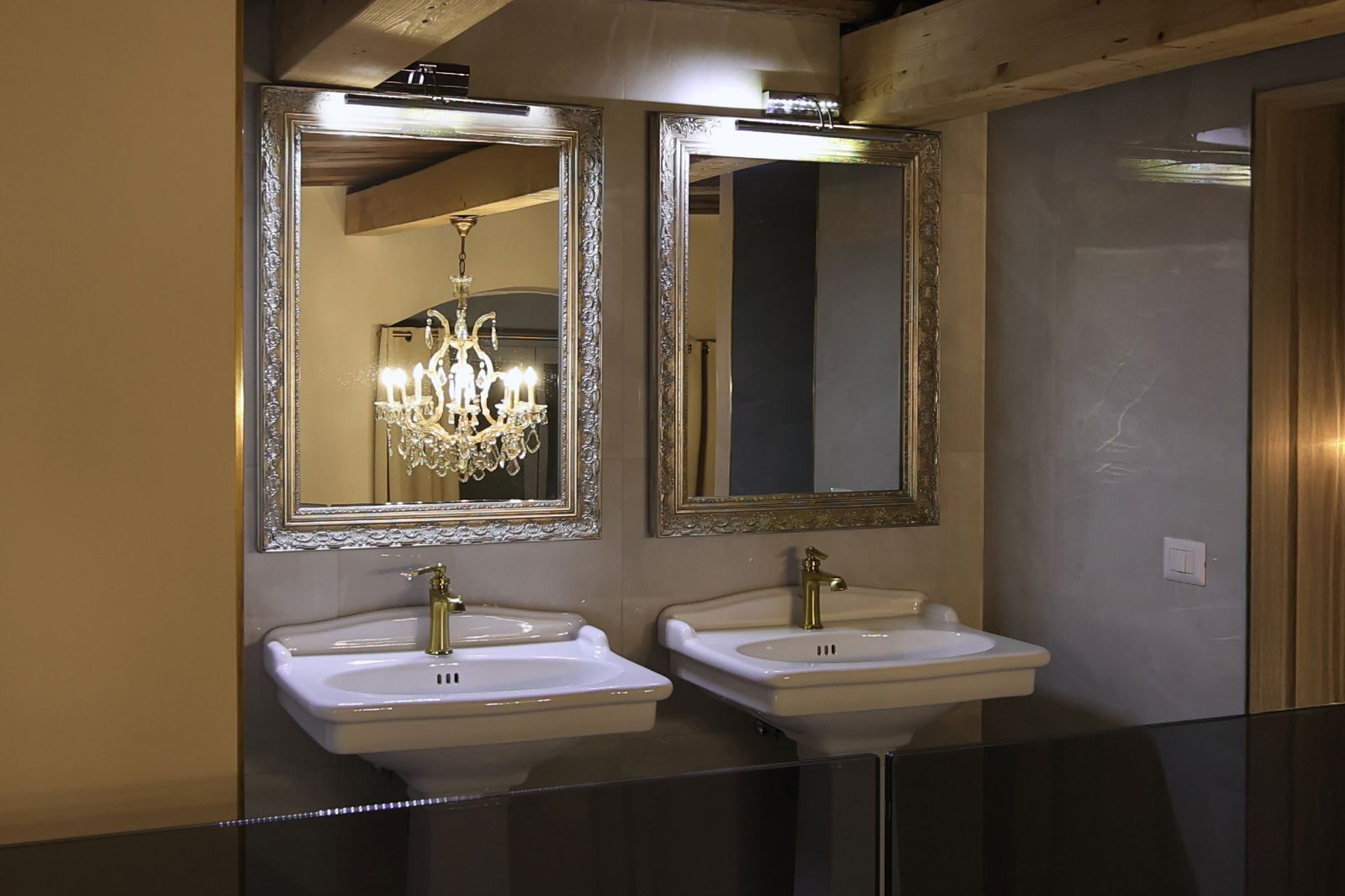 The chandelier, reflected in the twin mirrors.