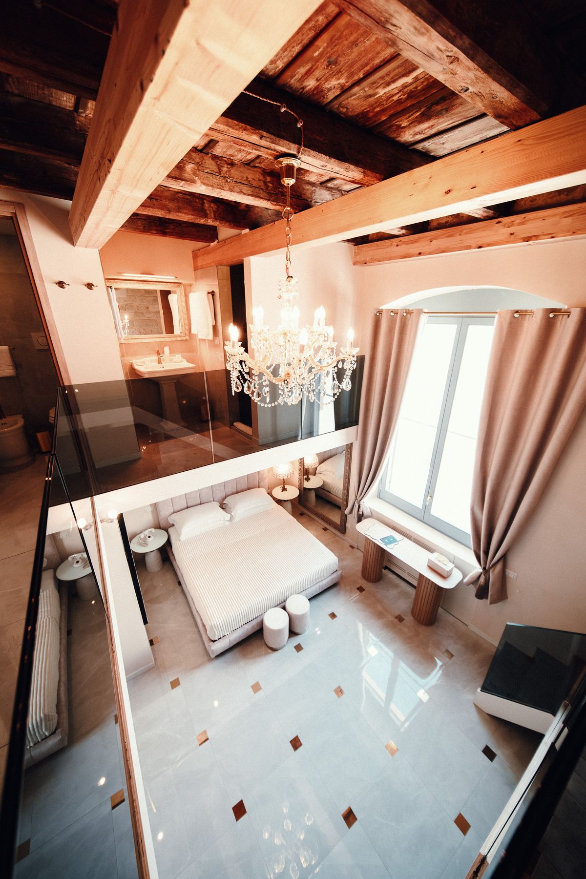 The bedroom from the mezzanine, bright with daylight.