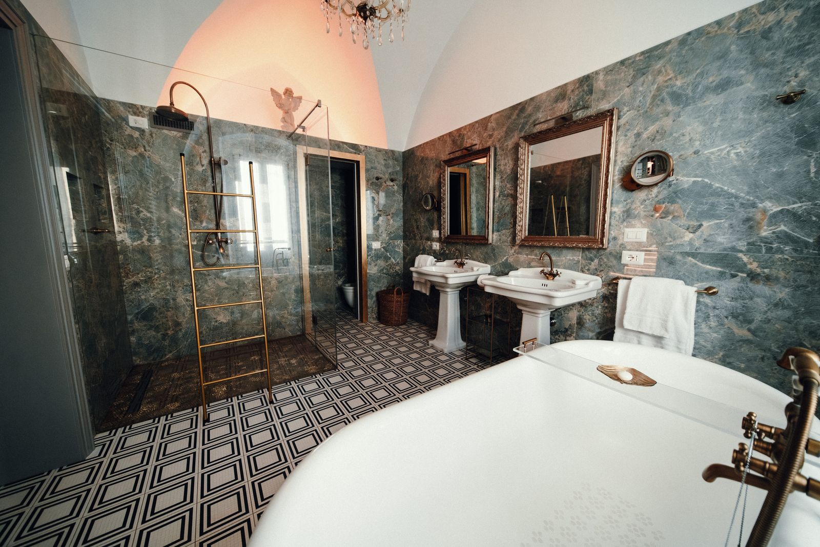 Gold mirrors over the twin basins.