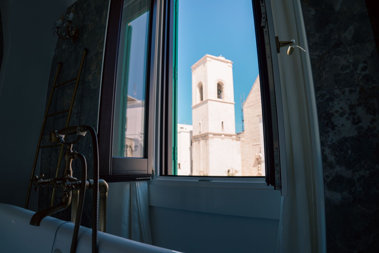 From the window, the white bell tower.