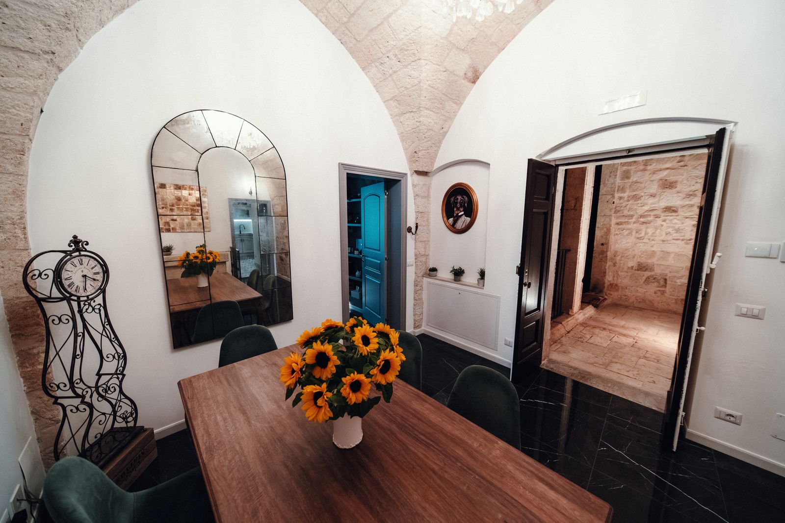 Sunflowers on the dining table, the arched mirror behind.
