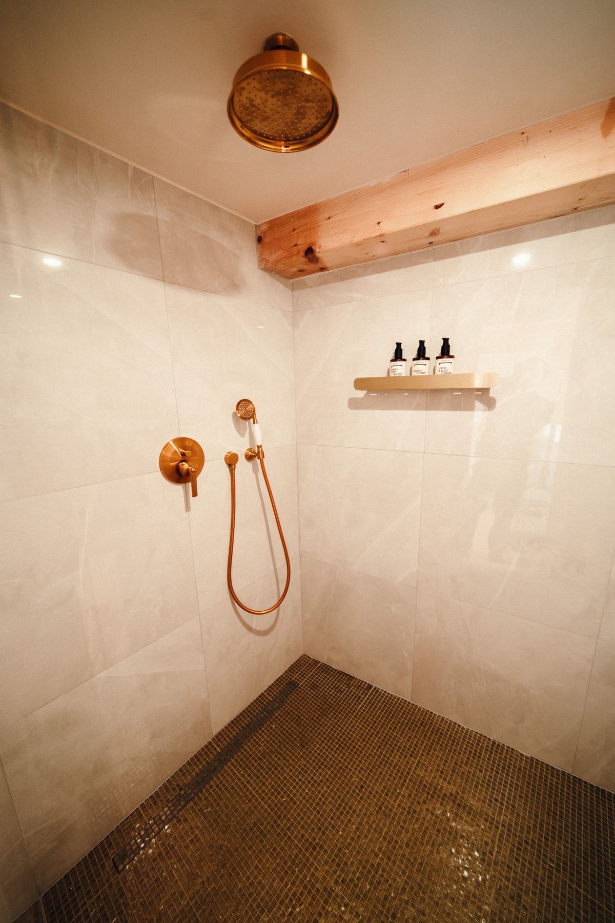 The walk-in shower and its copper rain head.