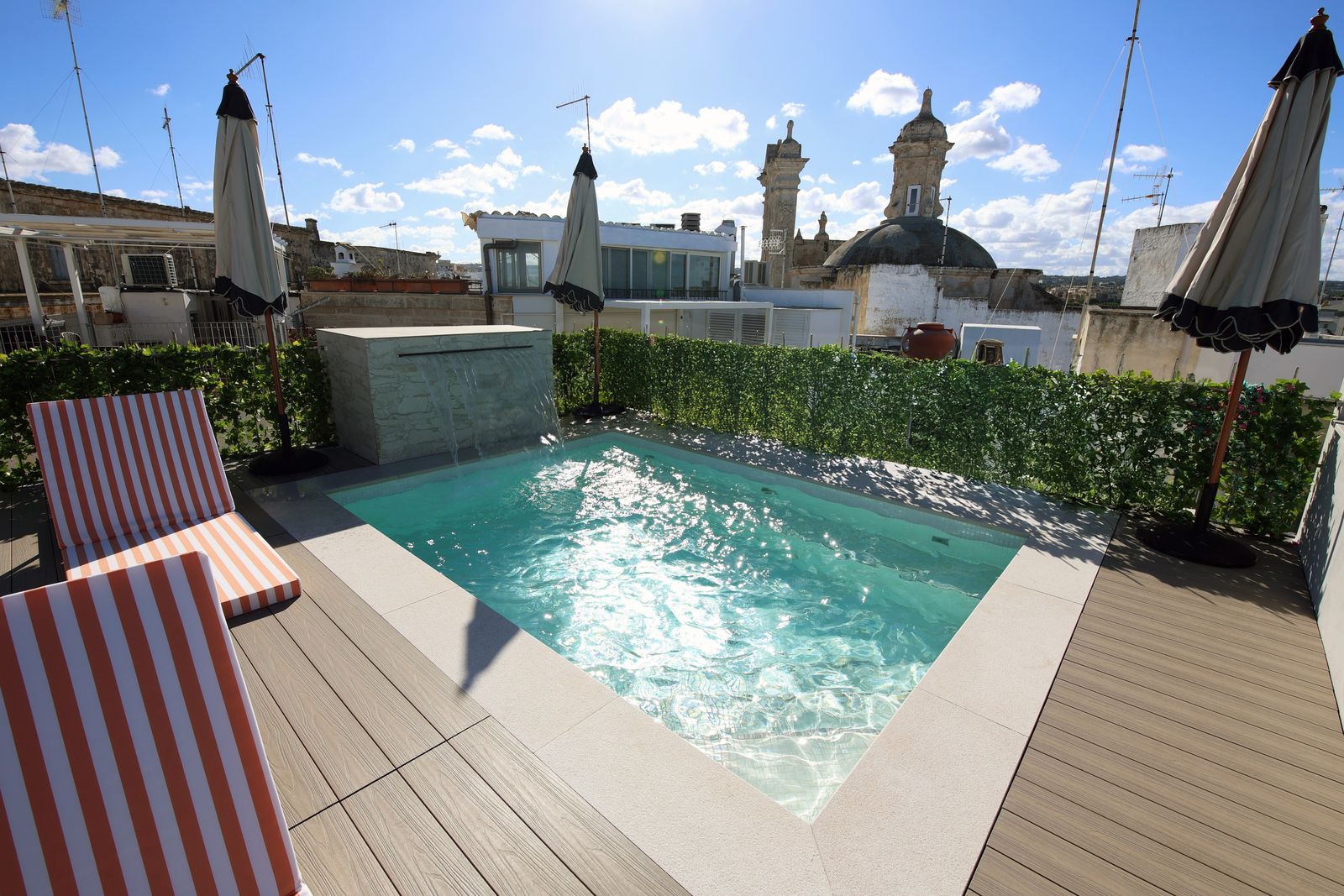 The pool, the striped loungers and the domes.