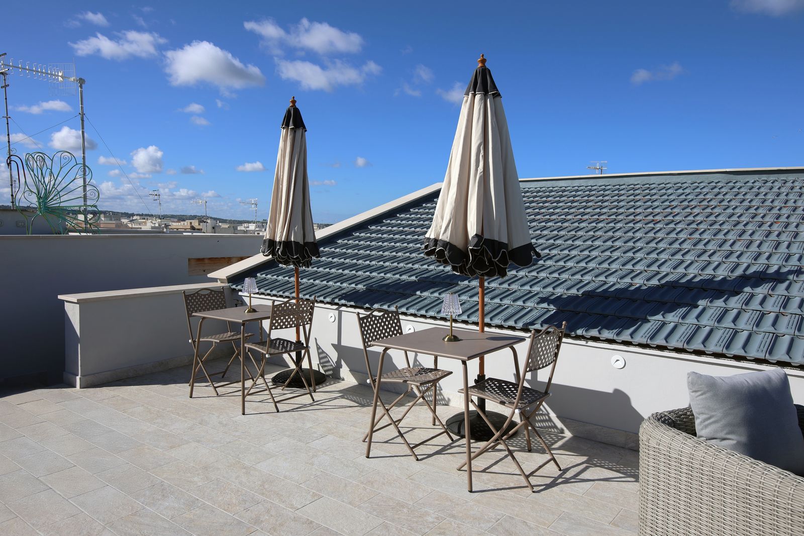 Parasols and bistro tables on the rooftop.
